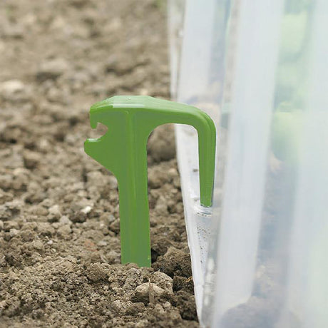 Hellgrüne Mehrzweck-Heringe von NOOR aus Kunststoff zur Befestigung und Belüftung von Pflanztunneln im Garten.